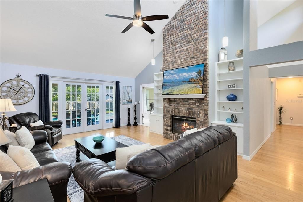 A massive family room with floor to ceiling brick fireplace offers a cozy environment.