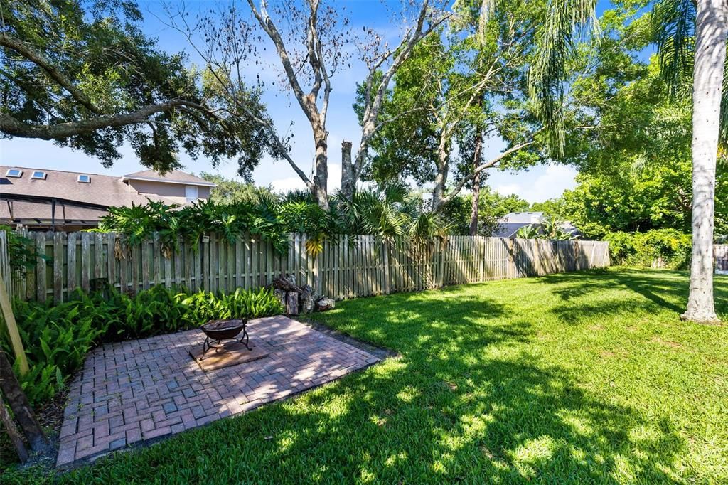 Huge sprawling fenced back yard with brick paver patio for entertaining.