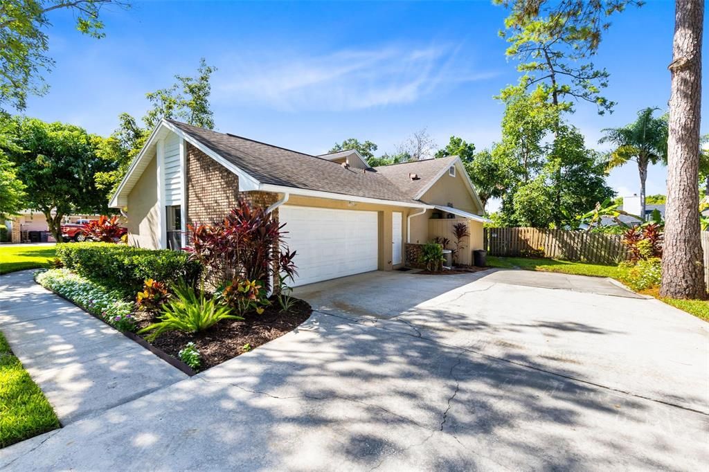 Side entry 2 car garage and large driveway for extra vehichles and with allowable boat and small RV parking permitted behind the fence.