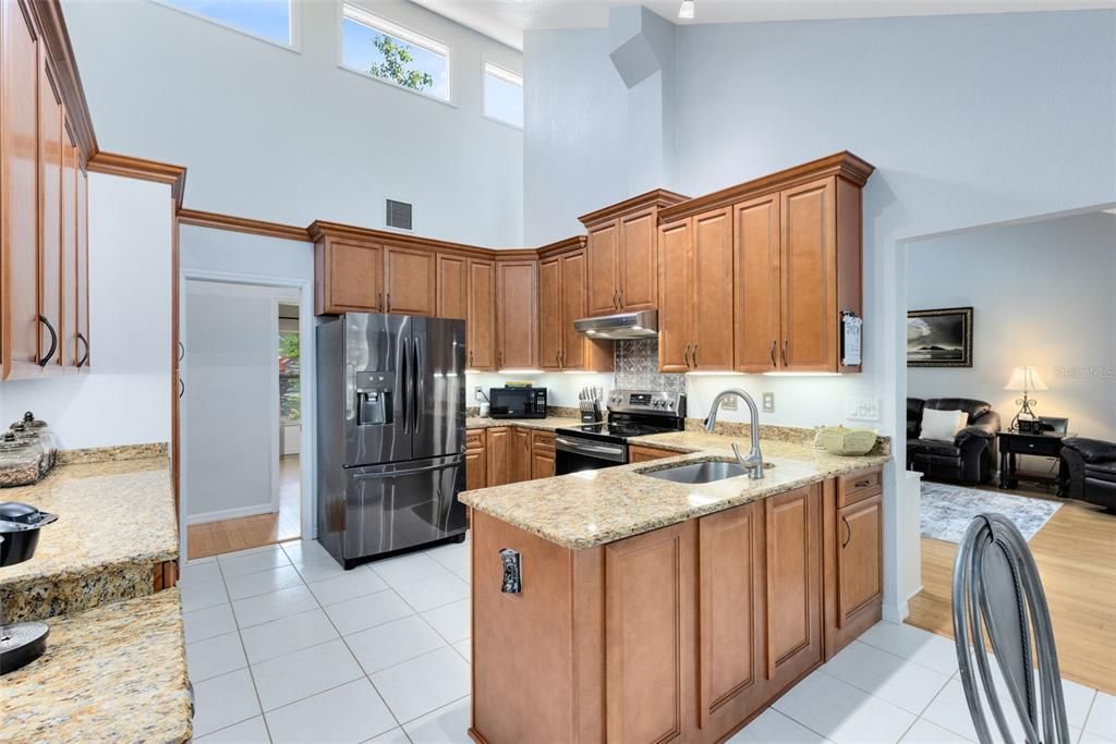 Updated kitchen with beautiful wood cabinetry, granite countertops, updated cabinetry and appliances.