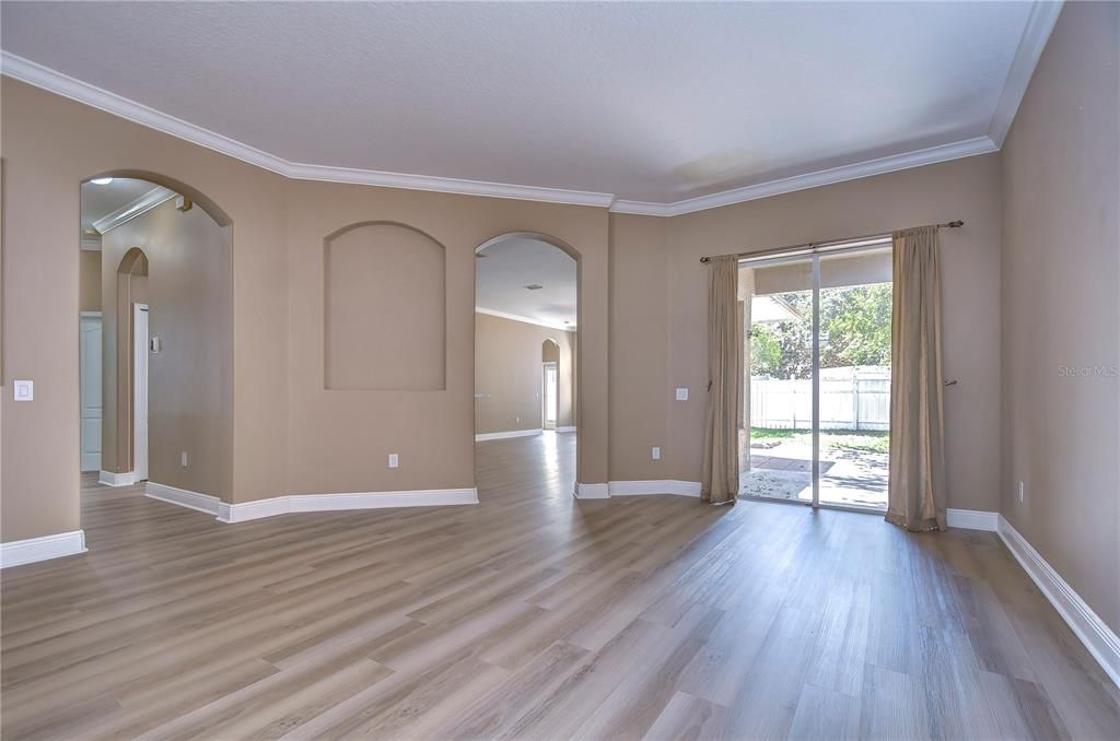 Soaring high ceilings, elegant crown molding, new flooring, and an abundance of natural light!