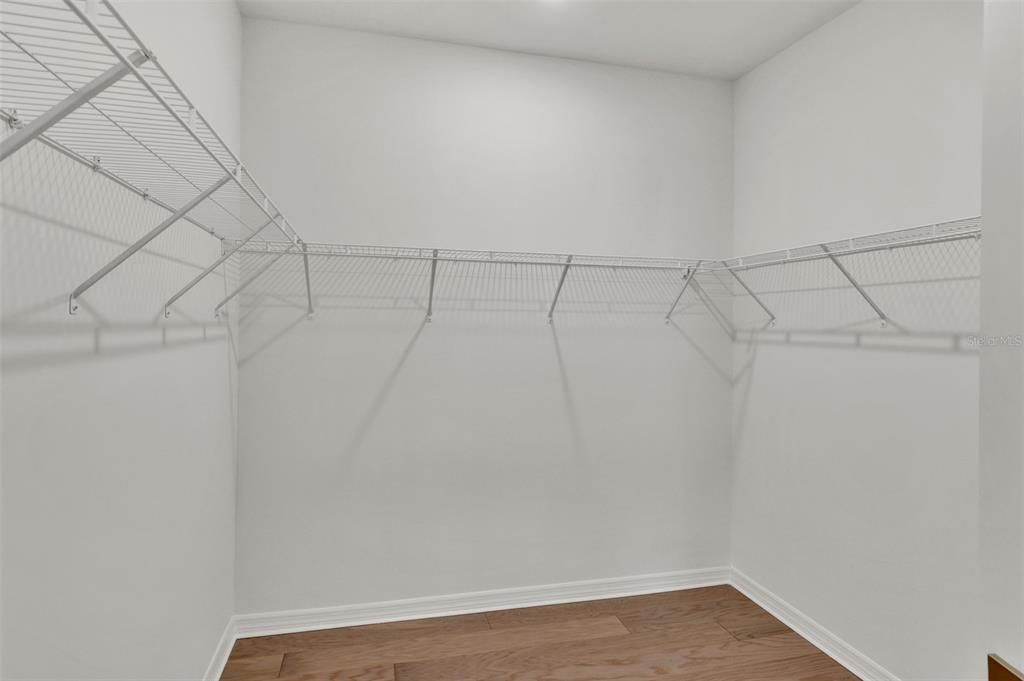 Primary bedroom walk-in closet