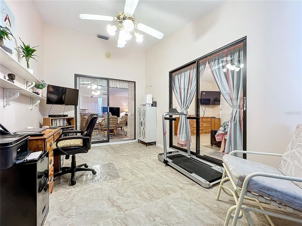 View of the den/Florida room looking into the dinette area and primary bedroom.