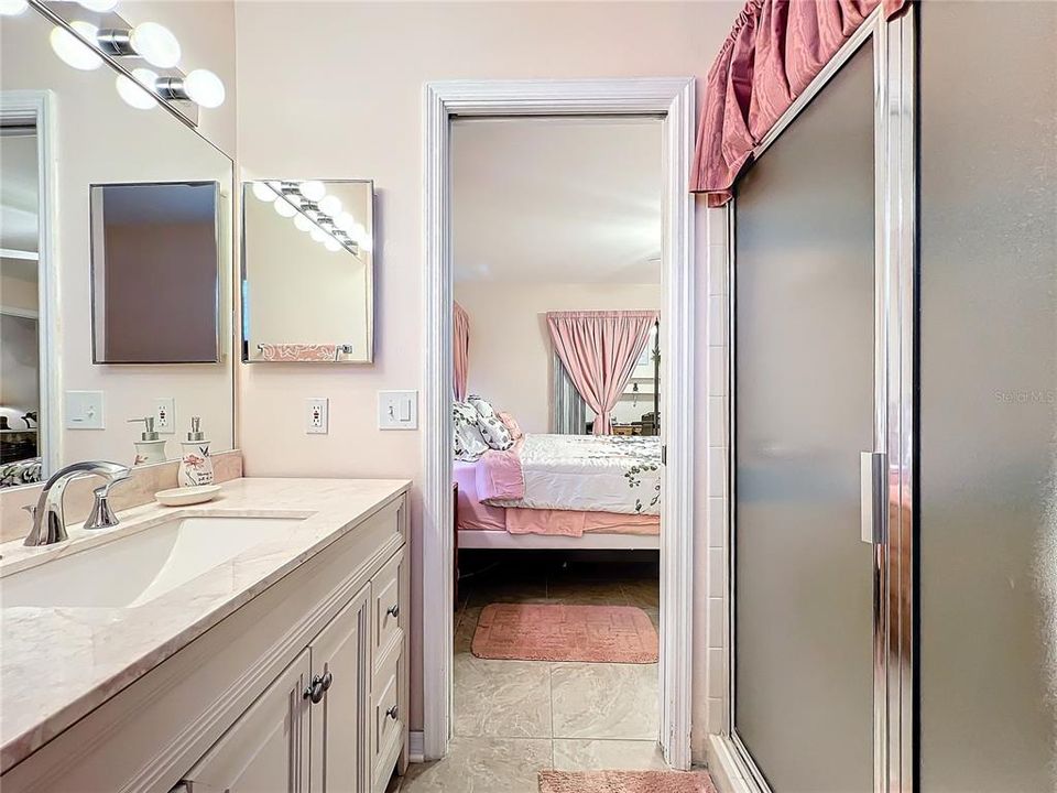 View of the primary bathroom looking into the primary bedroom.