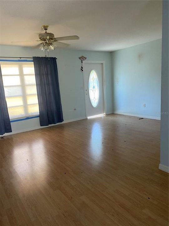 Living room looking at front door and window.