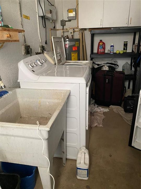 Laundry room  washer, new dryer, large deep sink and cabinet storage.