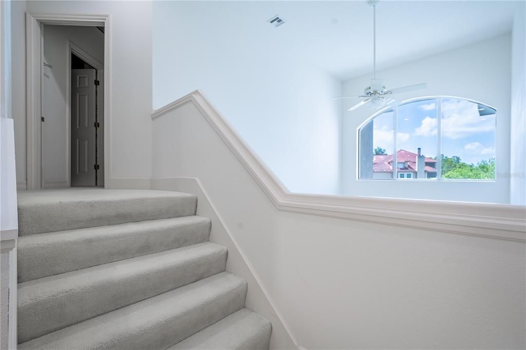 Natural light flows throughout the home from the large transom window in the living room.