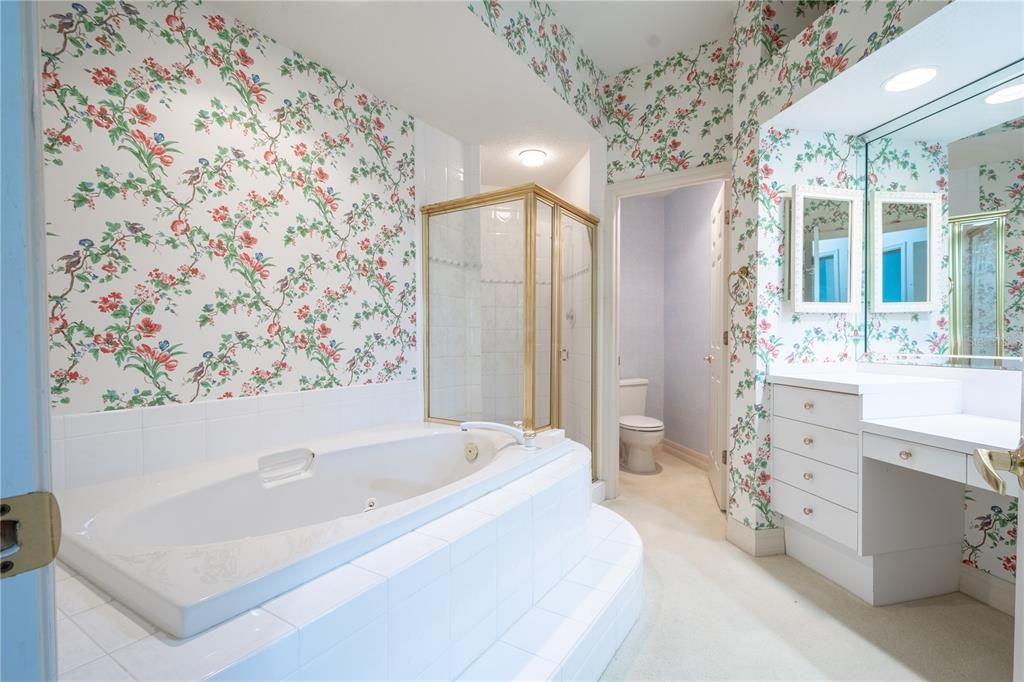 The primary, ensuite bath features a jetted garden tub, a separate walk in shower and a private water closet.