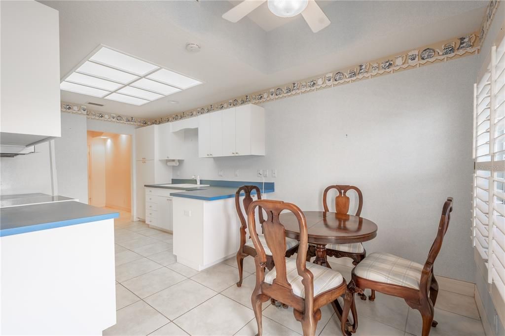 The kitchen features a breakfast nook with ceiling fan and light kit.