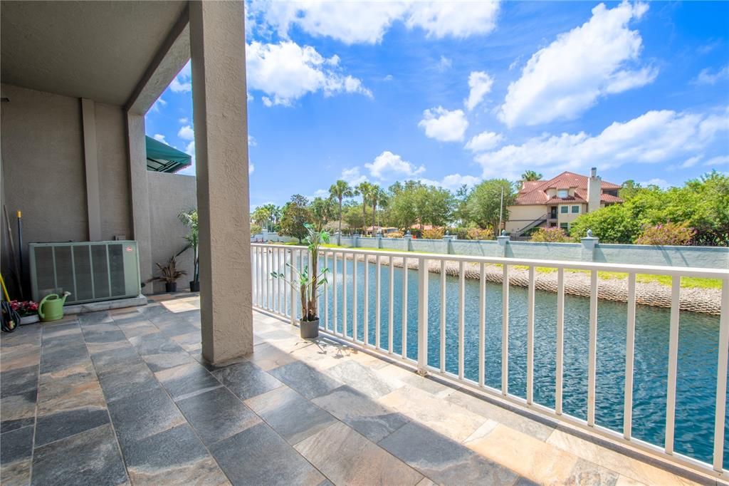 The large, tiled balcony overlooks the pond.