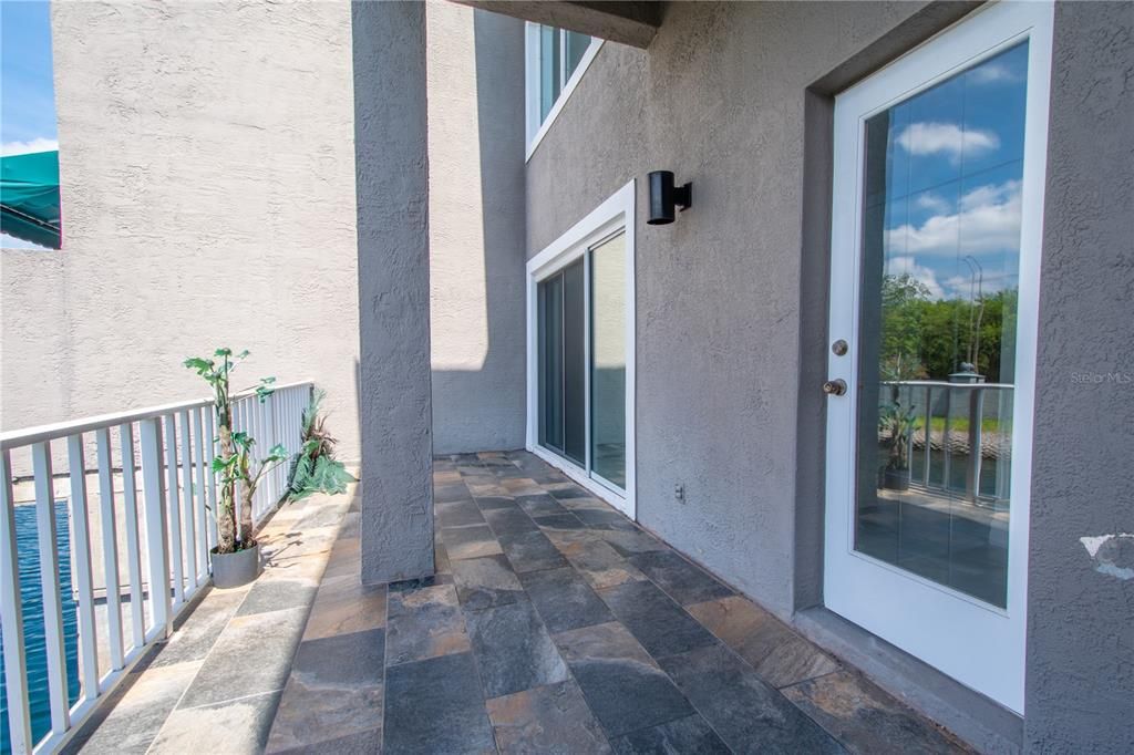 There is access to the covered balcony from both the kitchen and living room.