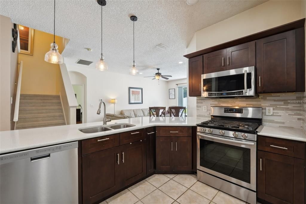 OVERSIZED KITCHEN Renovated in 2020 with UPGRADED QUARTZ COUNTERTOPS, NEWER STAINLESS-STEEL APPLIANCES, GAS RANGE, NEW CABINETS & PLENTY OF ROOM for an EAT-IN KITCHEN SPACE.