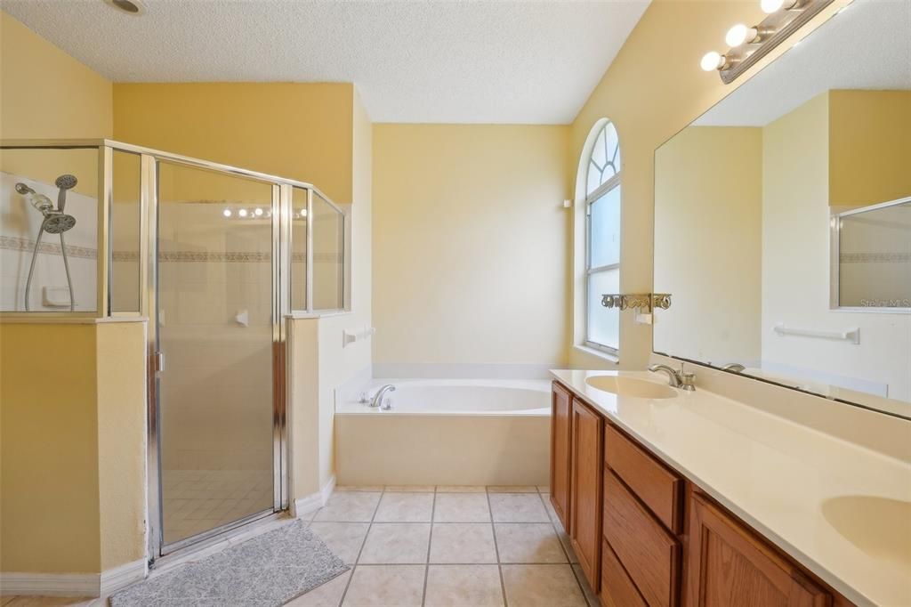 PRIMARY BATHROOM that is ALSO OVERSIZED and complemented with DOUBLE SINKS, a GARDEN TUB and a STAND-UP SHOWER WITH A GLASS DOOR! LUXURY LIVING AT IT’S FINEST!