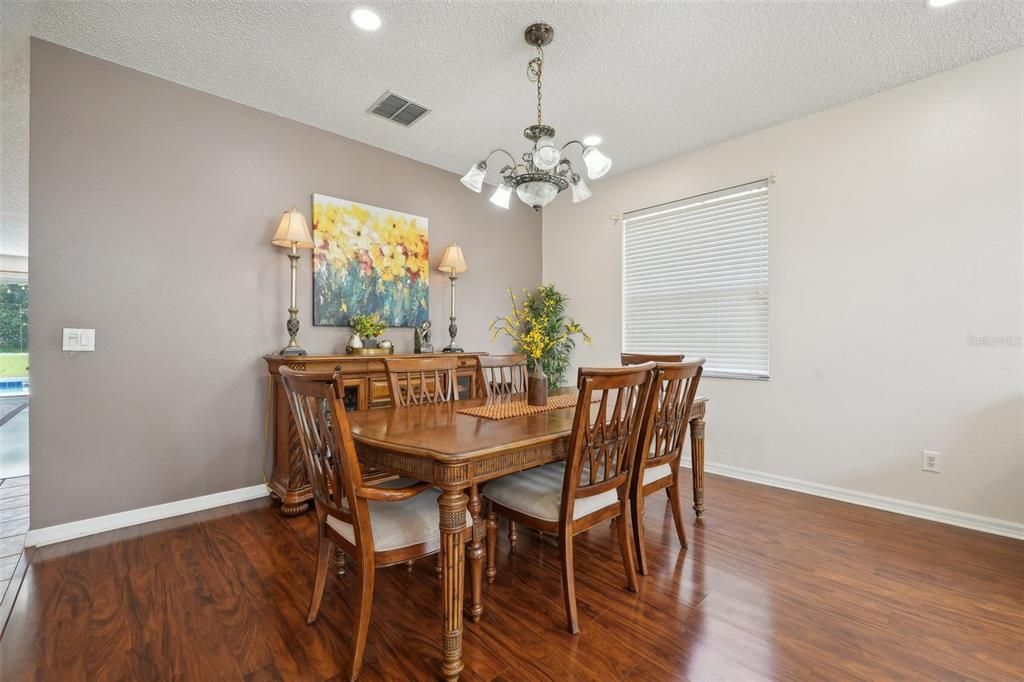 Formal Dining Room with beautiful Laminate Flooring and lots of natural light