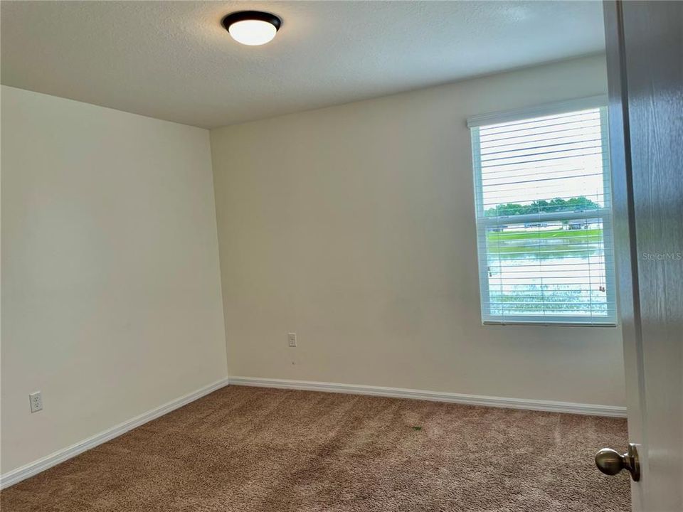 Bedroom 4 with backyard Pond view