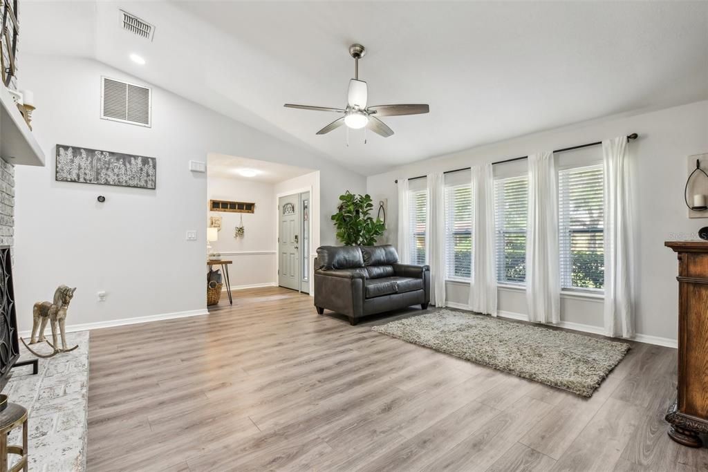 Living Room with Vaulted Ceilings, Tons of Natural Light, New Flooring and refurbished Fireplace