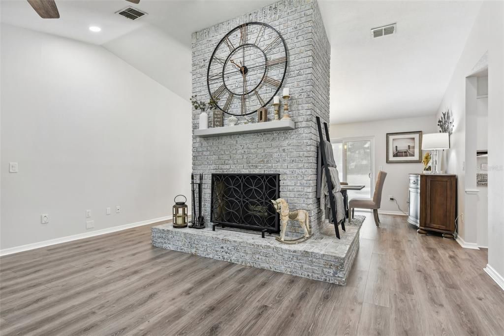 Living Room with Vaulted Ceilings, Tons of Natural Light, New Flooring and refurbished Fireplace