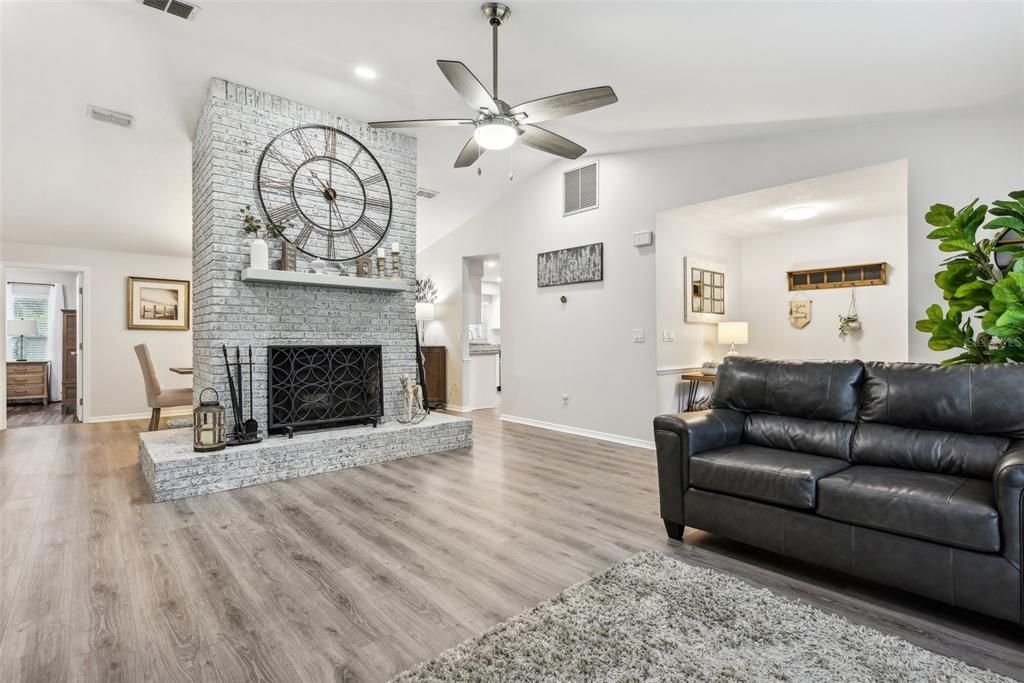 Living Room with Vaulted Ceilings, Tons of Natural Light, New Flooring and refurbished Fireplace