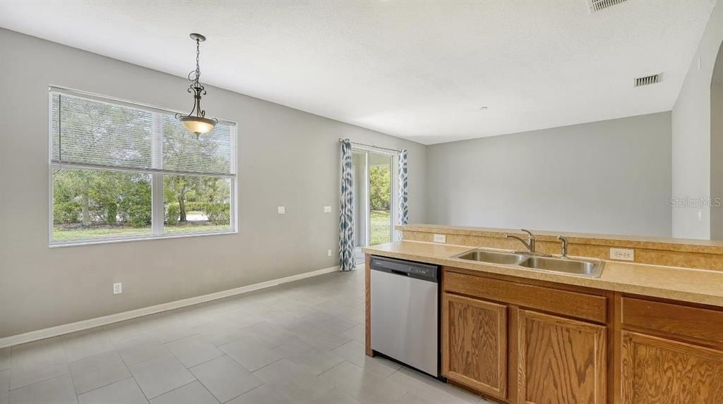 Spacious kitchen featuring ample cabinetry, solid surface countertops, stainless steel appliances, and more!