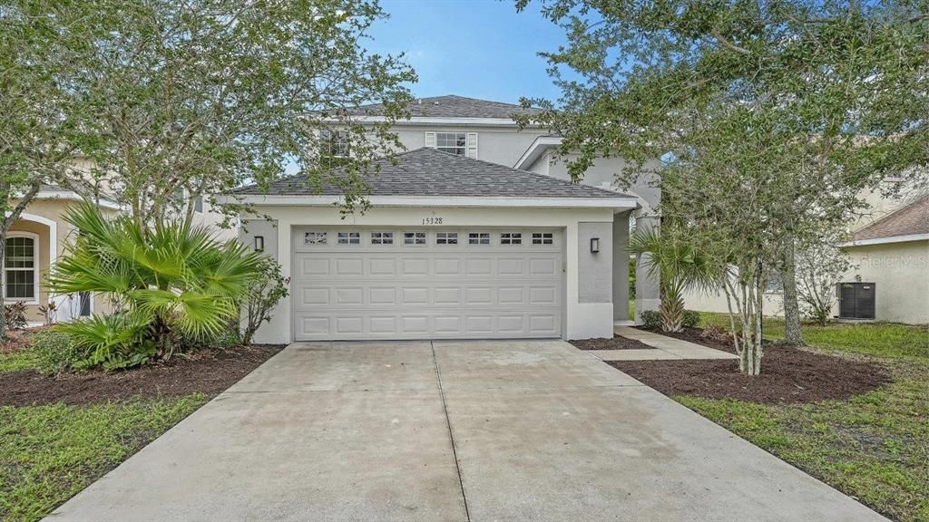 Front Elevation showing the landscaping and front entryway.