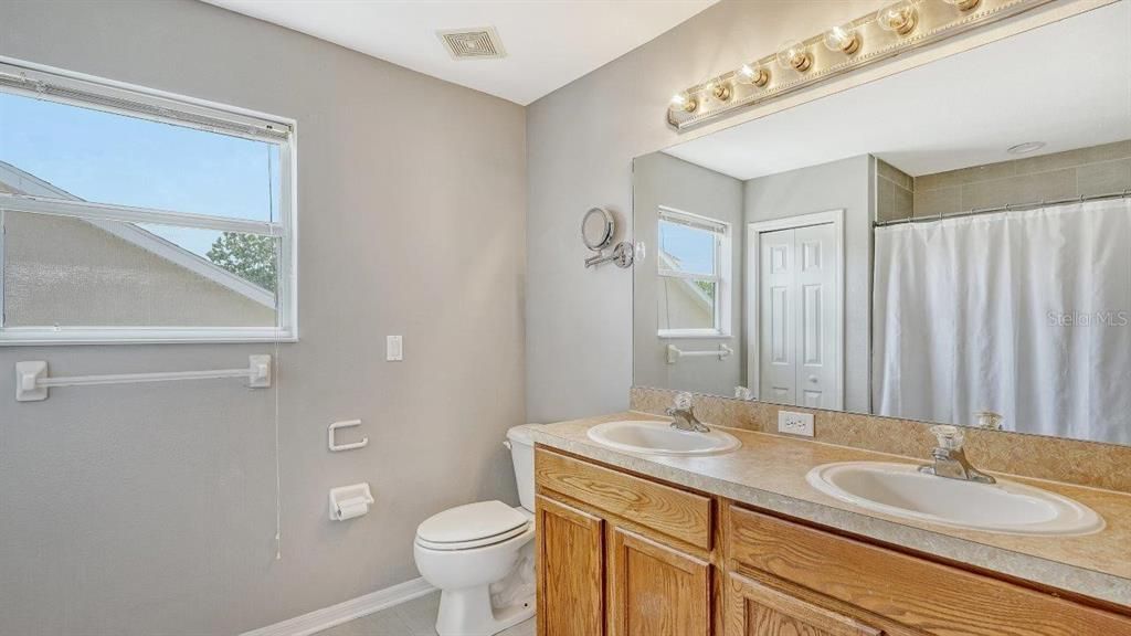 Owners ensuite bathroom featuring dual sinks, and a walk-in shower.