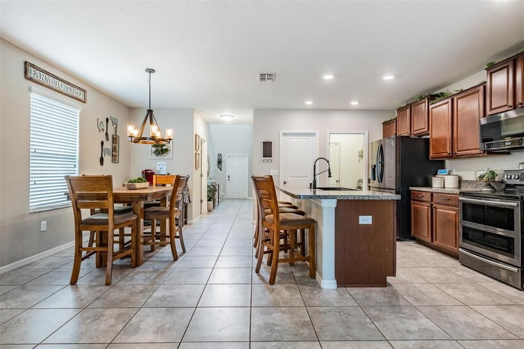 view of kitchen, dining and front door