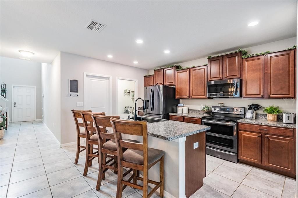 kitchen with views of front door pantry and laundry room