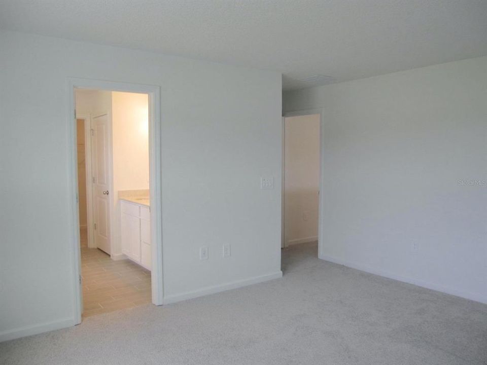 Primary bedroom toward private bathroom