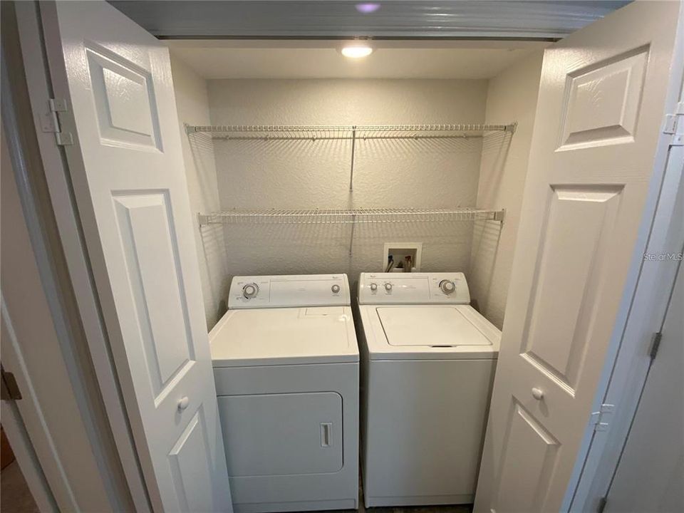 Utility closet with double shelving & can lighting