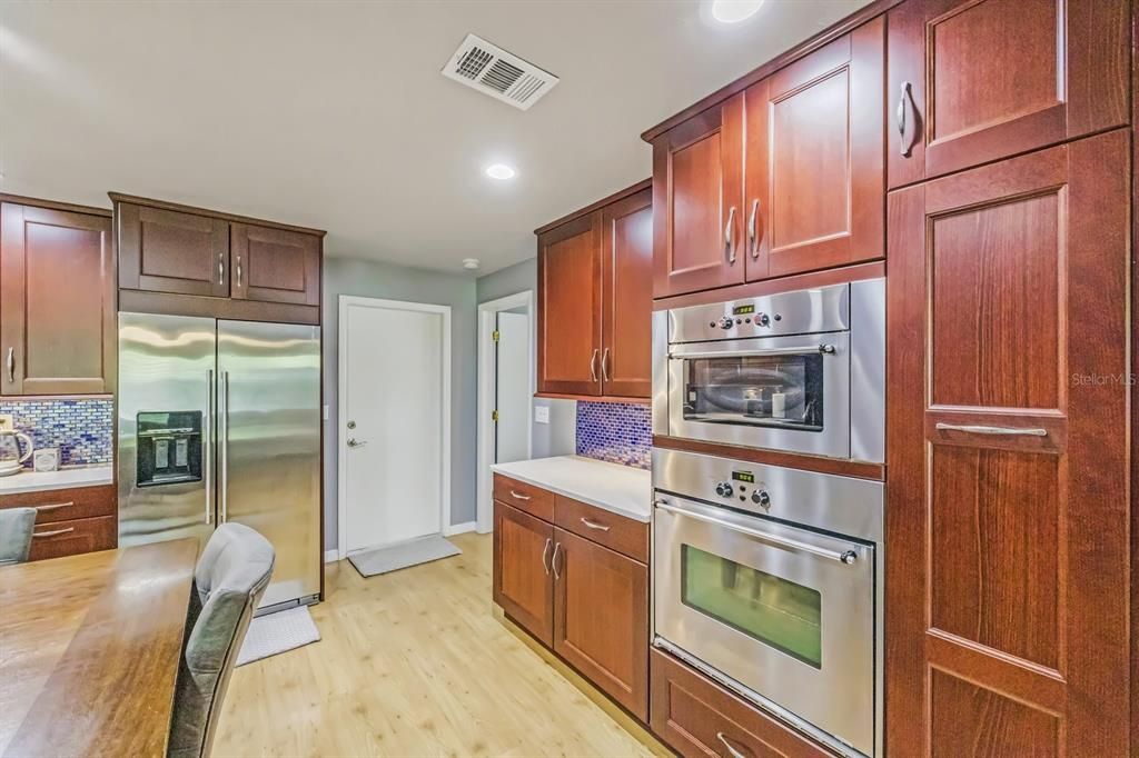 Kitchen with desk. Large pull out pantry to the right of oven and microwave.
