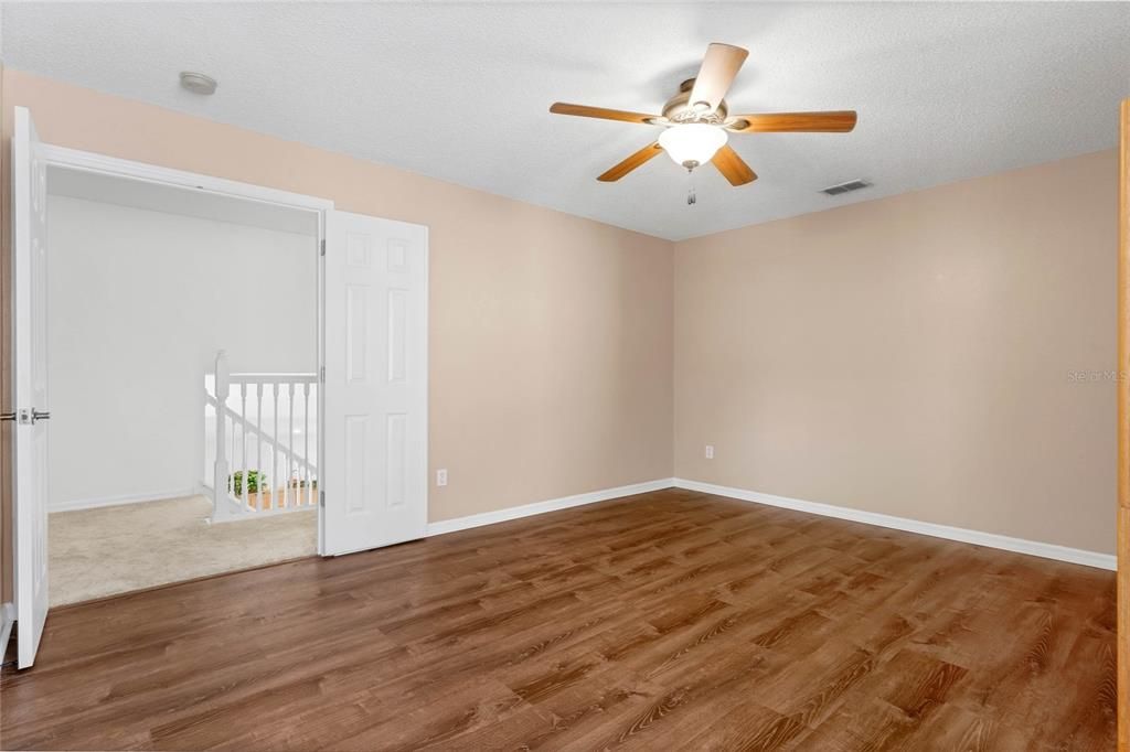 Bedroom 4 with walk in closet and vinyl plank floors