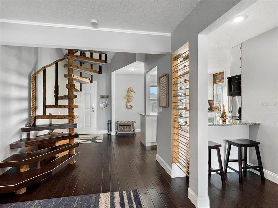 Kitchen with bar seating and entryway