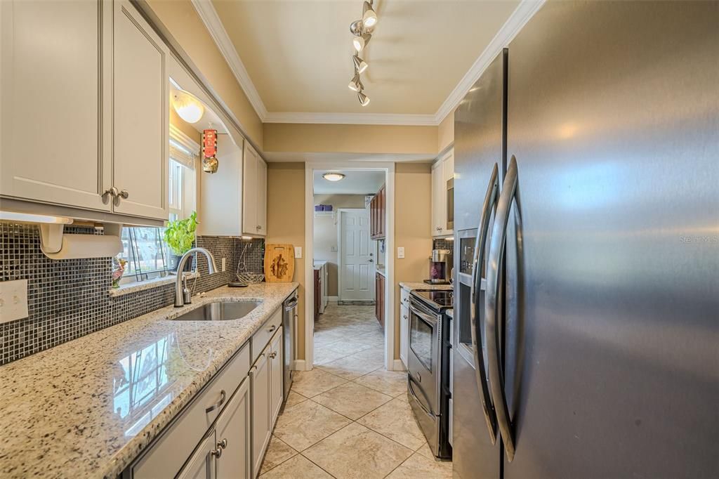 Kitchen with granite counter tops and stainless appliances