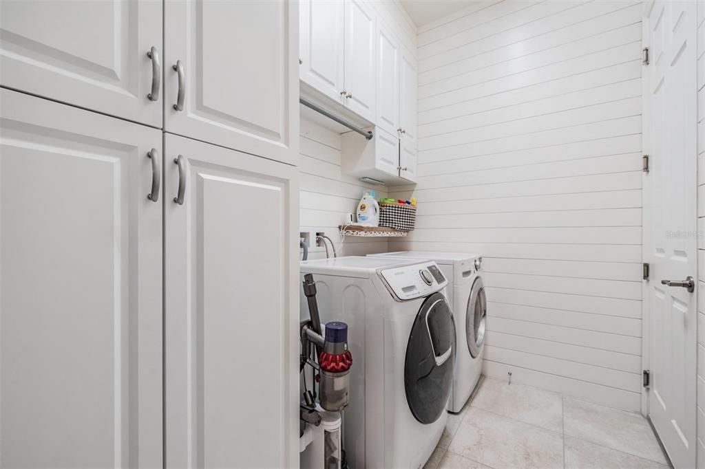 Laudry room offers plenty of cabinets, washer and dryer stay!