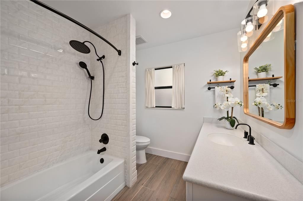 Fresh, tastefully decorated bathroom with corian counter tops.