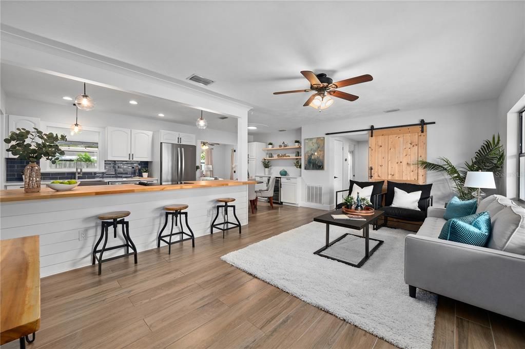 Crown molding, shiplap lower cabinets, bar top seating, barn door. Modern farmhouse at it's finest.