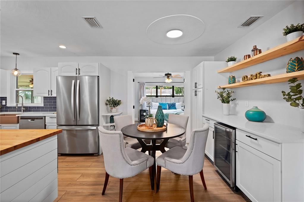 closer look at the dry bar with decorative floating shelves. Also look at the shiplap feature on the lower cabinets.