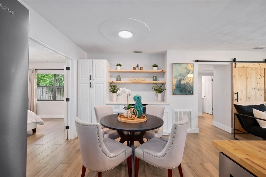 Notice the Bard Door. Just enough space for a eat in kitchen space. Dry bar with cabinets, and quartz countertop in the background.