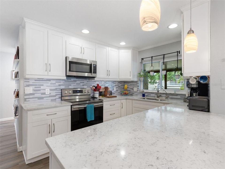 Brand new kitchen with stainless appliances and stone countertops