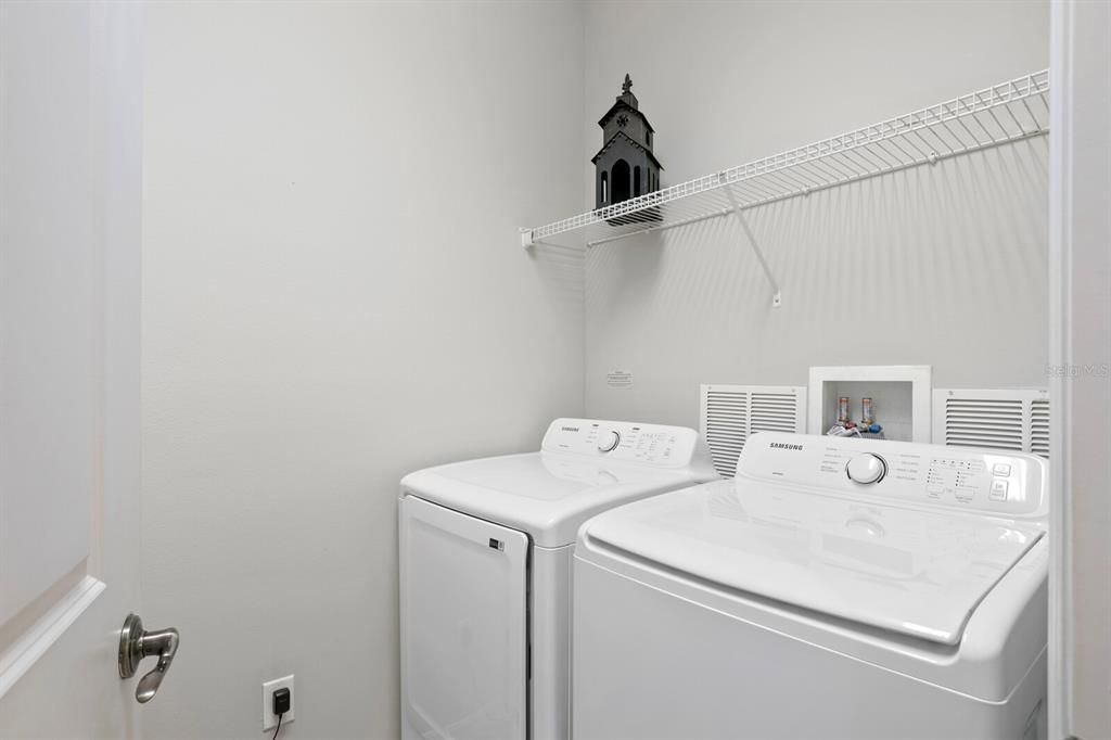 Laundry room with utility sink and washer/dryer included with home