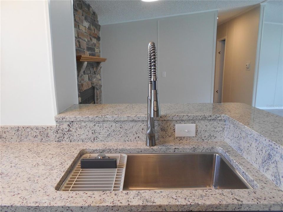 Beautiful granite counters.  View to hallway.  Split bedroom plan.