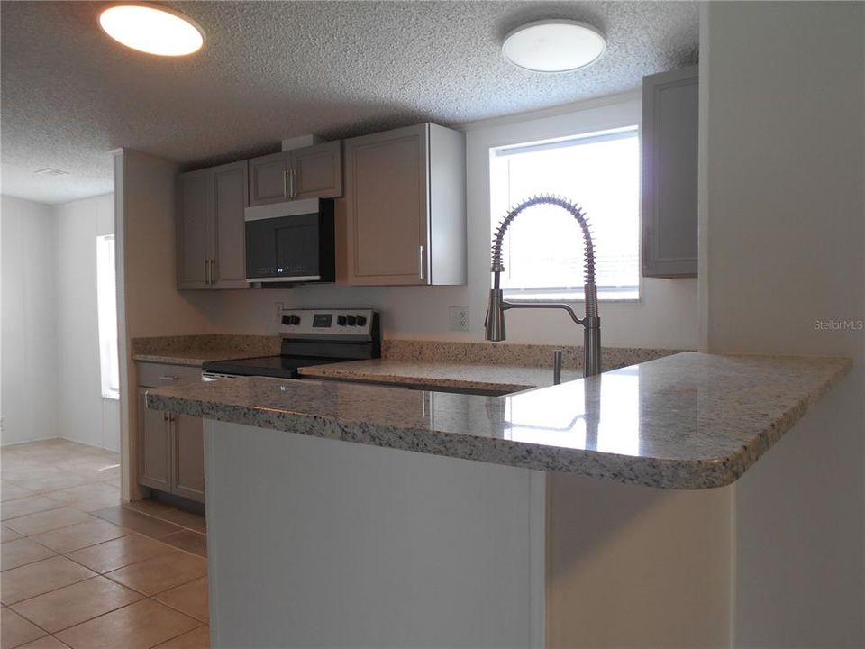 Kitchen features a snack counter for quick meals, or just gathering around the cook.