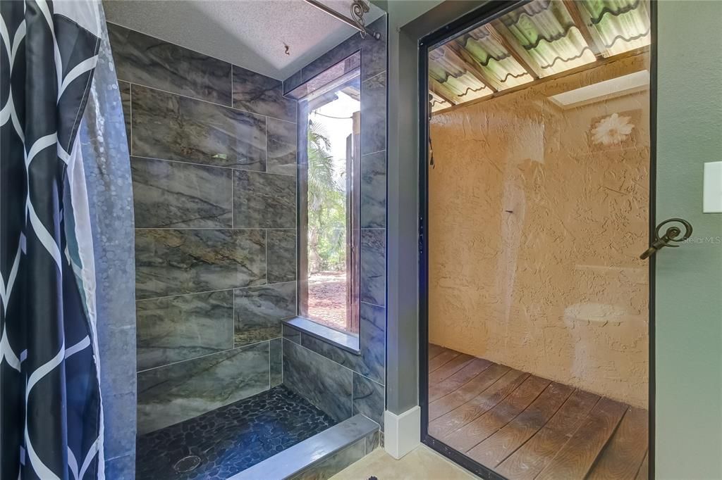 Single Sliding Door leads to an Outdoor Shower Area .. it can be brought to fully functional Outdoor Shower.. at this time, Seller warrants the outdoor shower AS IS..