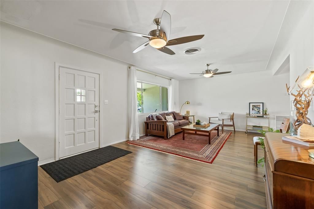 Large Living Room Features new Laminate Wood Flooring