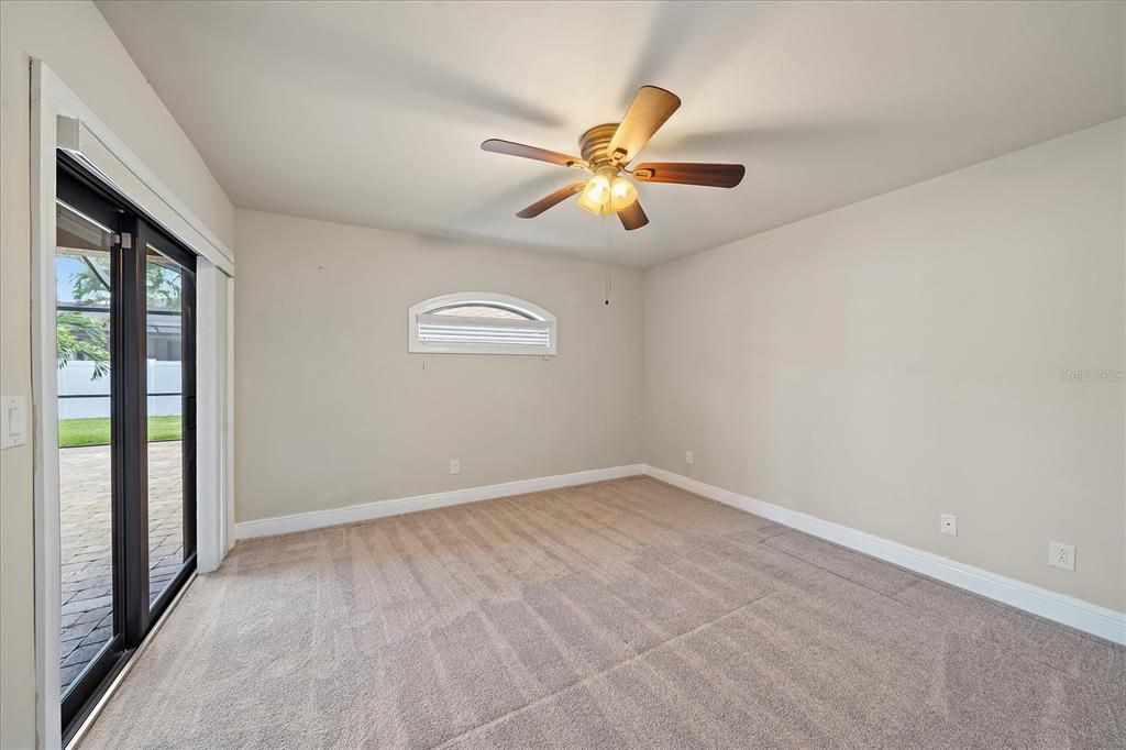 Bedroom 2 with access to pool/lanai