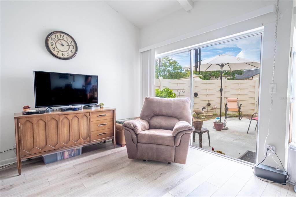 The living room get plenty of natural light from the sliding glass doors that open to the patio.