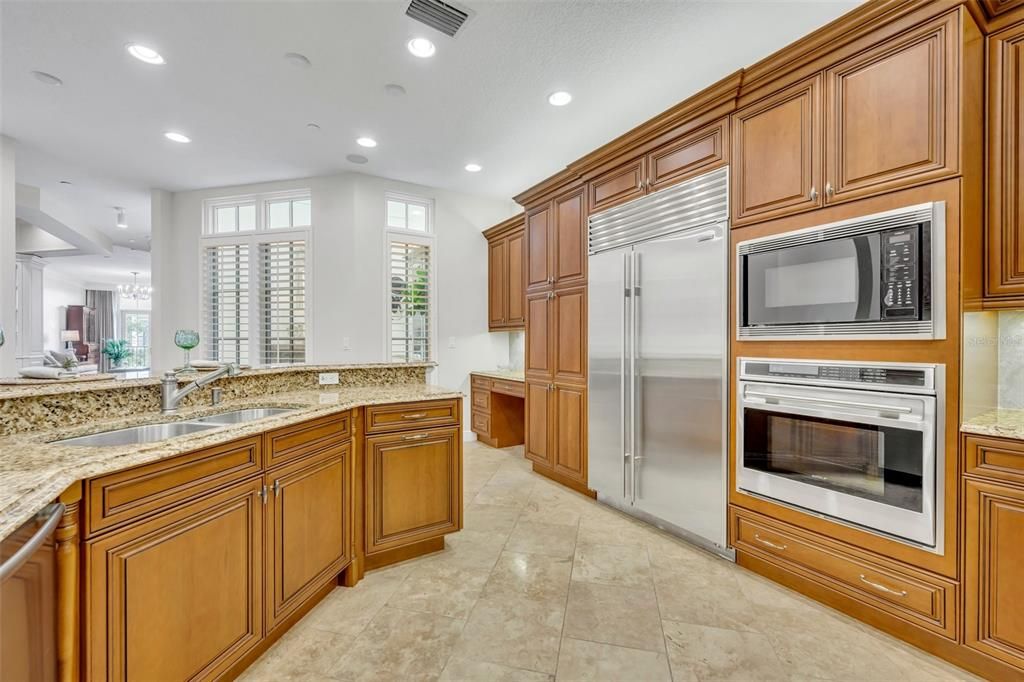 Kitchen with pantry cabinets (left of fridge) & a built-in desk