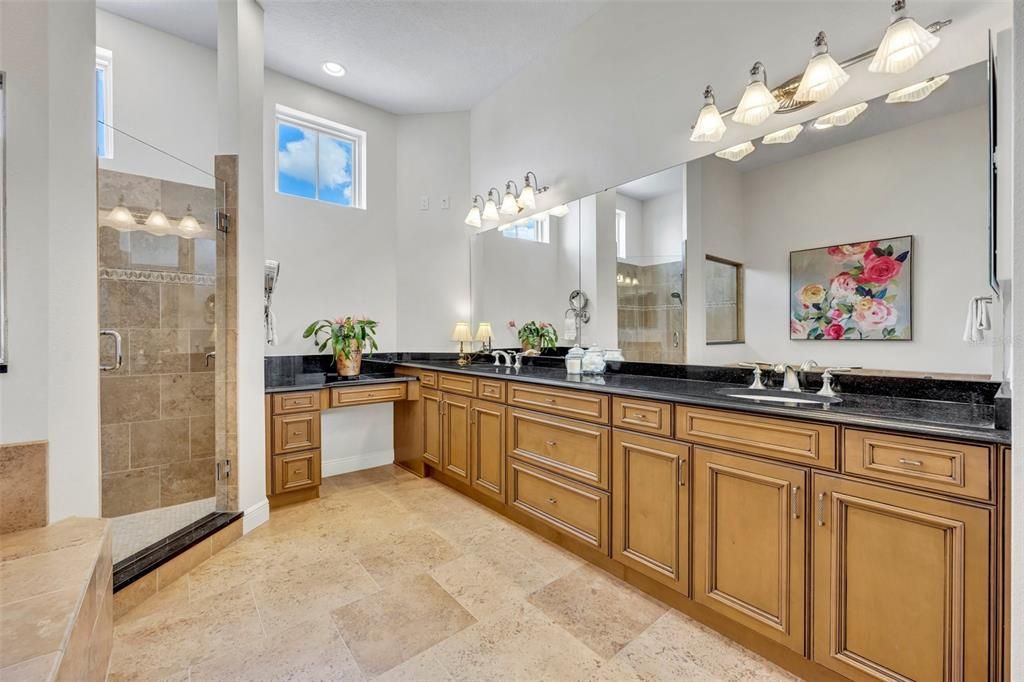 Primary bathroom- dual sinks plus a make-up vanity space, & a linen closet