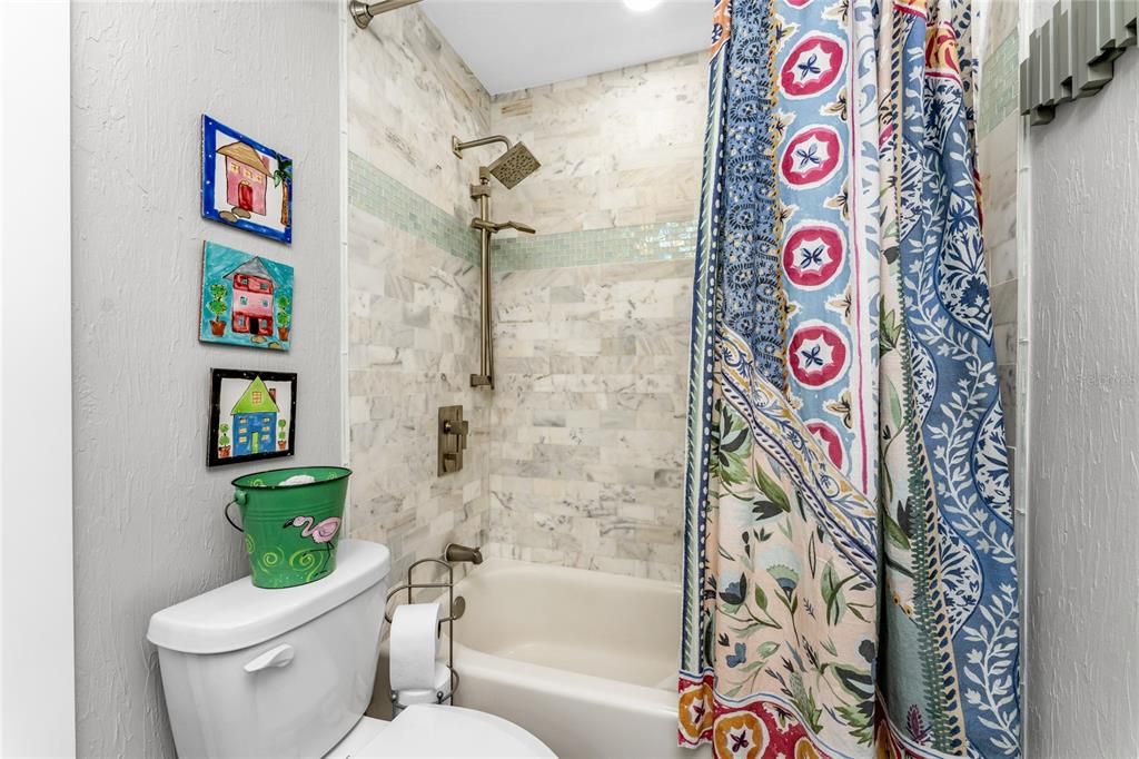 Remodeled Jack & Jill tiled tub/shower combination