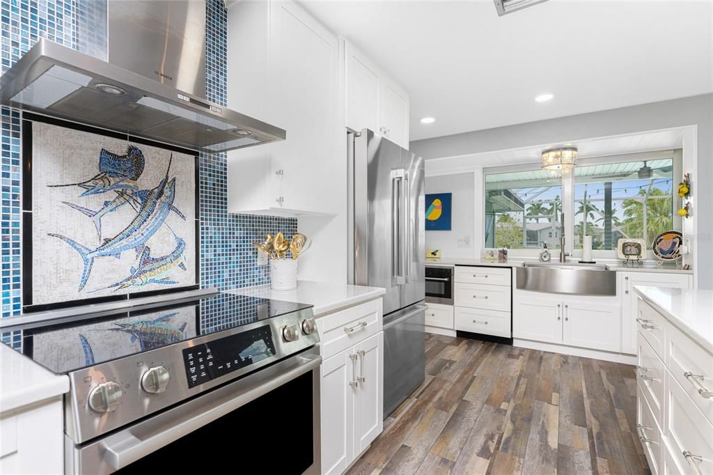 Whimsical blue and white fish mosaic tile inlay above cooktop range